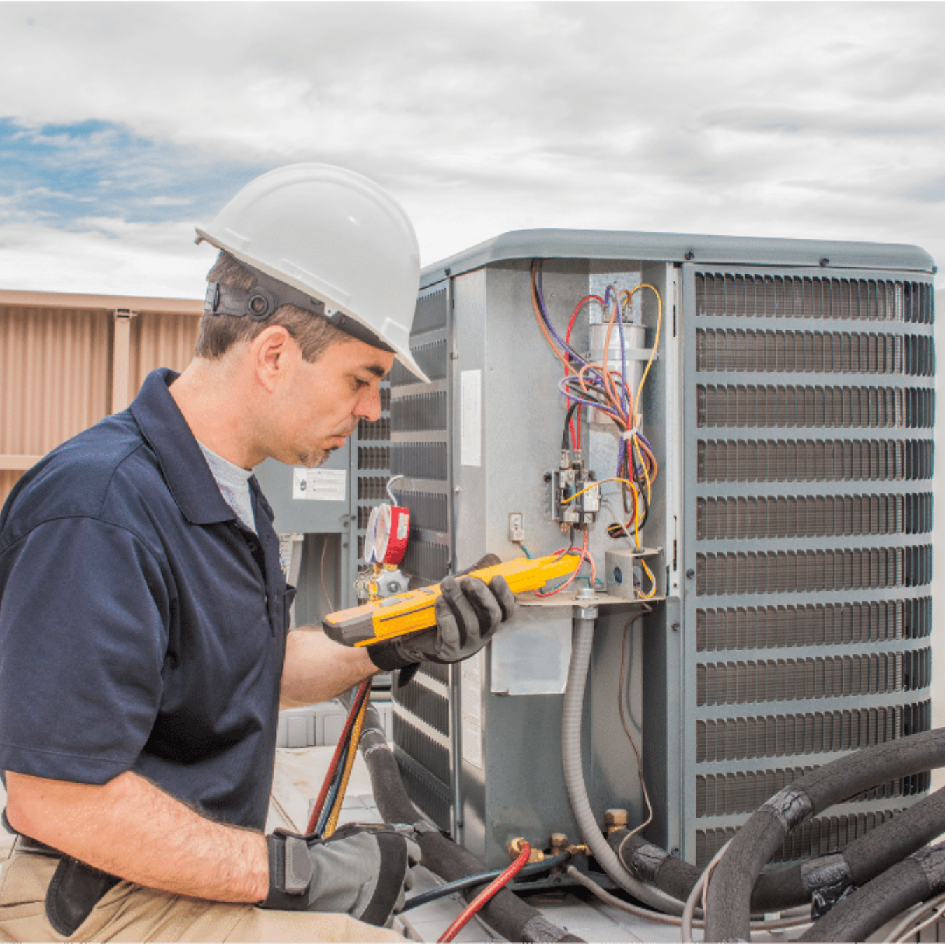 Brantford Heating & Cooling HVAC technician servicing a system
